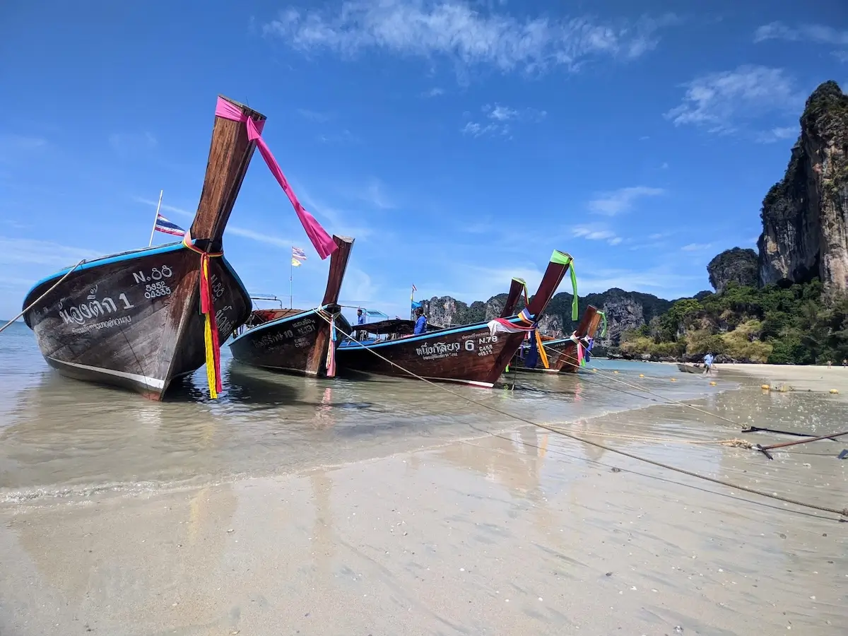 longtail boats on beach in Thailand